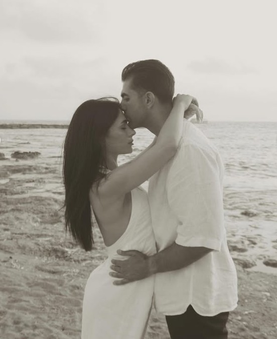Kyriakos kissing Maria's forehead on the beach