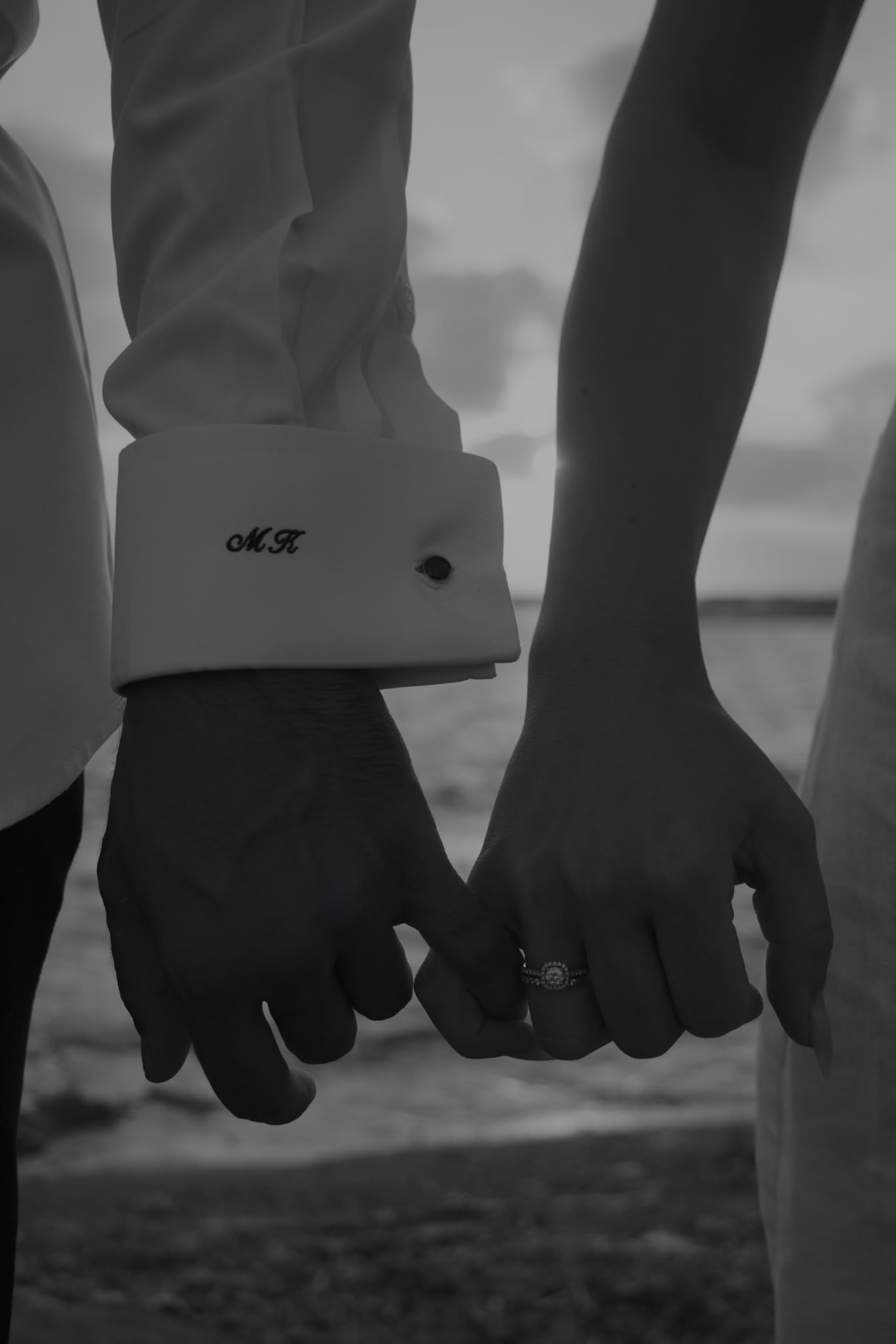 Kyriakos and Maria holding hands, her engagement ring catching the light